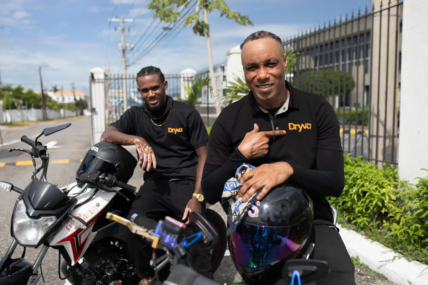 Two Dryva riders with their motorbikes